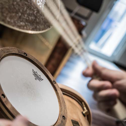 Session drummer's hand playing a ride cymbal shuffle pattern