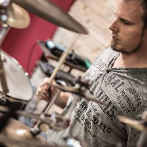 Session drummer playing medium tempo Samba groove on drumset